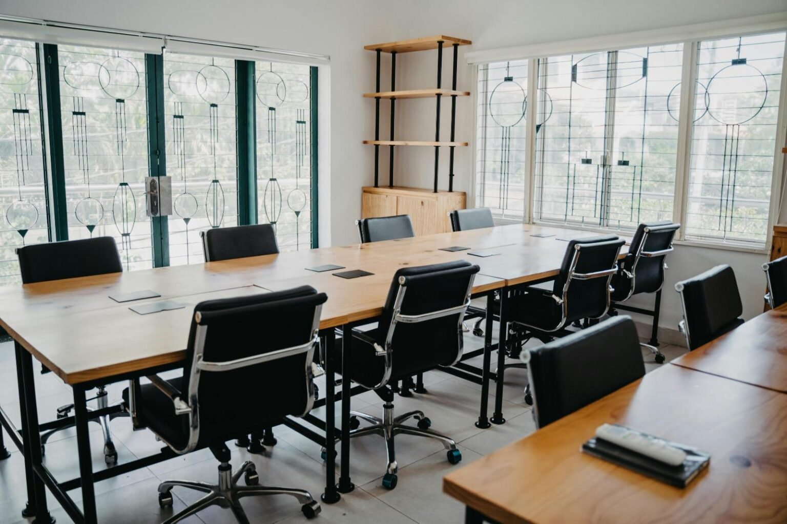Office area with wooden tables and large windowa.