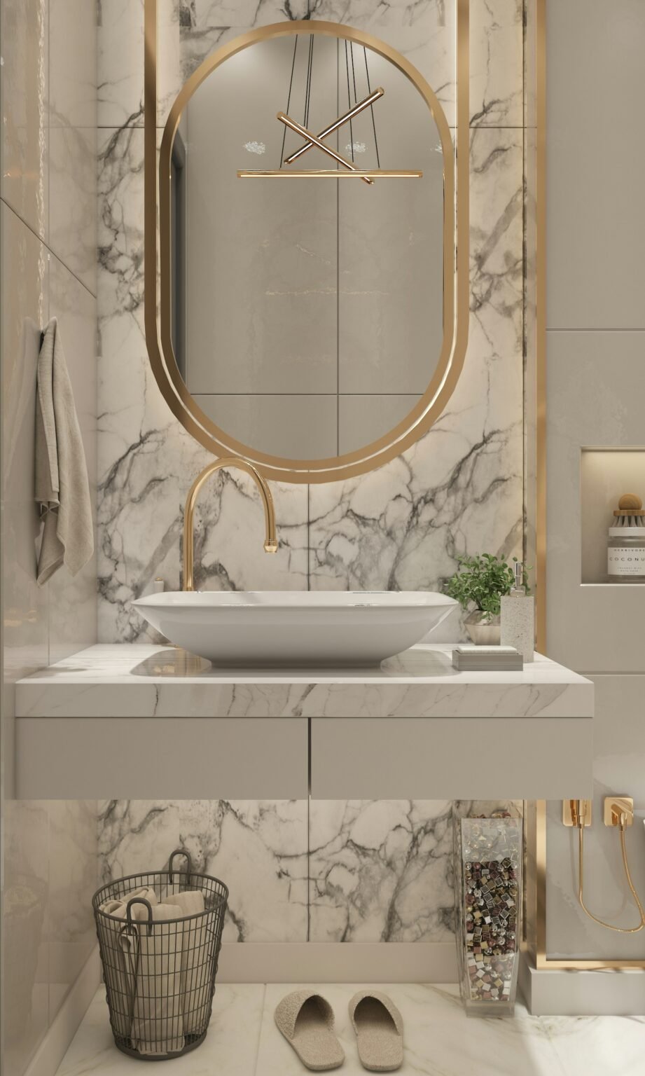 Bathroom remodeling in Manhattan. Elegant modern bathroom vanity with a sculptural gold-framed oval mirror, wall-mounted gold faucet, and a white vessel sink set against a luxurious marble backsplash. The design features soft lighting, built-in shelving, and a contemporary pendant chandelier reflected in the mirror.