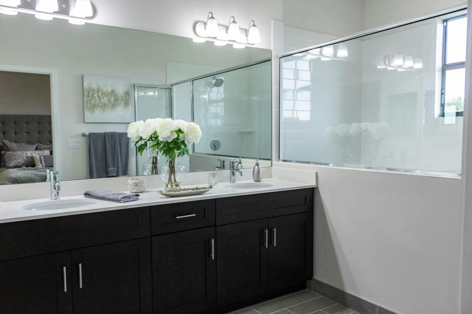 large luxury bathroom with a double vanity and wall mirror.