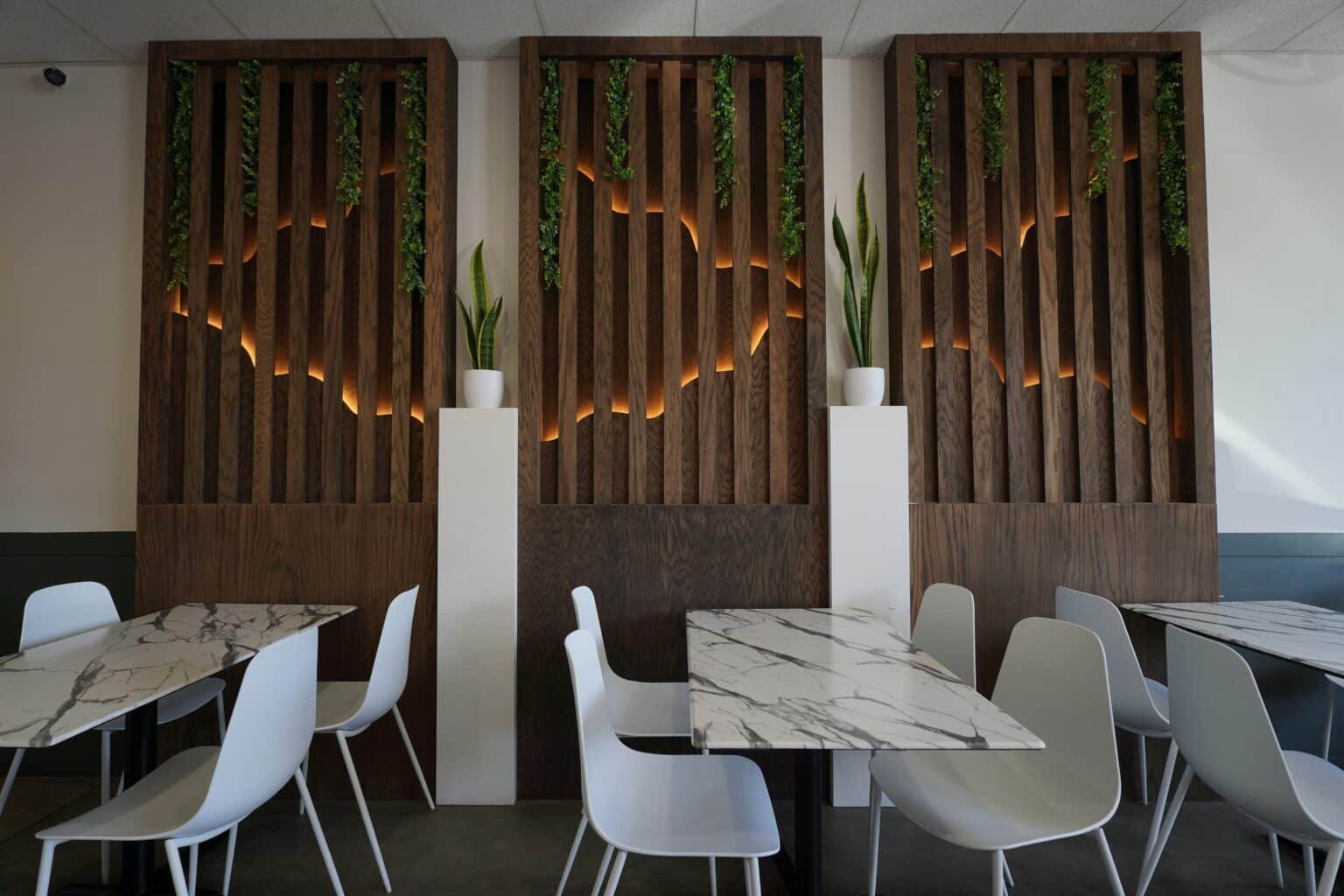 Commercial interior design and remodeling in Manhattan. Restaurant with white seats and wood paneling
